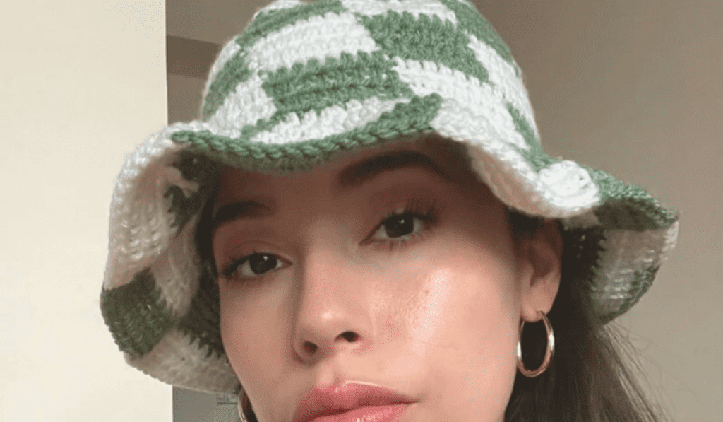 A checkerboard pattern on a crochet bucket hat with green and white squares.