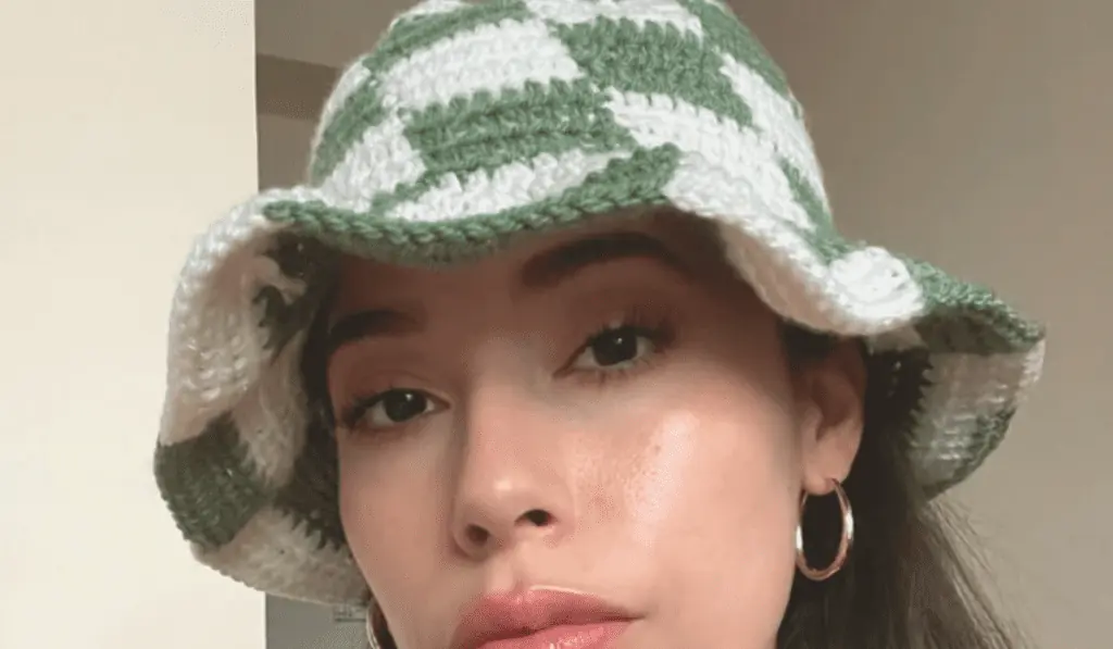 A checkerboard pattern on a crochet bucket hat with green and white squares.