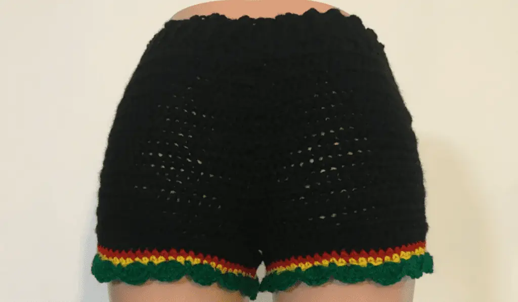 Black crochet shorts with rows of red, yellow, and green on the bottom.