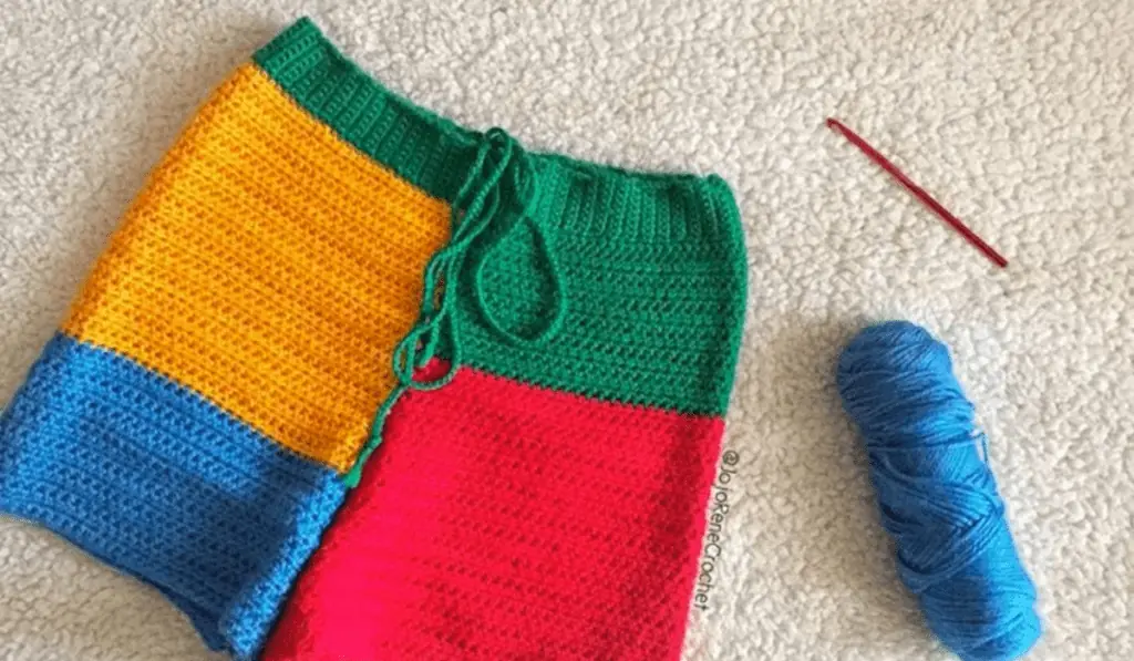 Color-blocked crochet shorts with blocks of blue, yellow, red, and green.