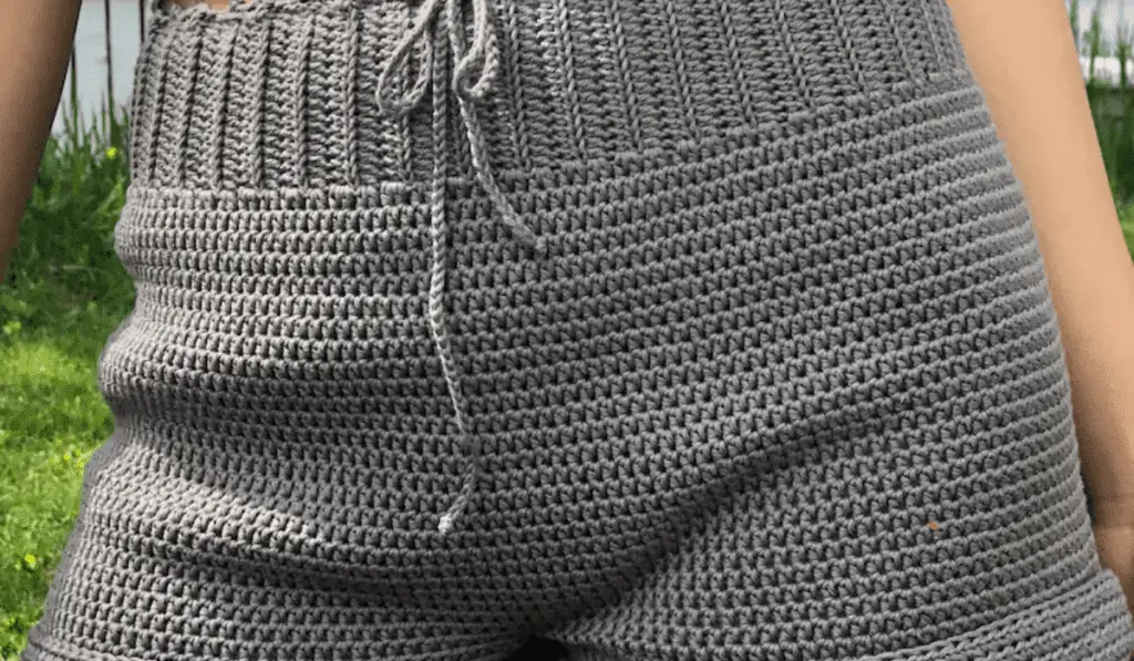 Grey crochet shorts with a drawstring a ribbed waistband.