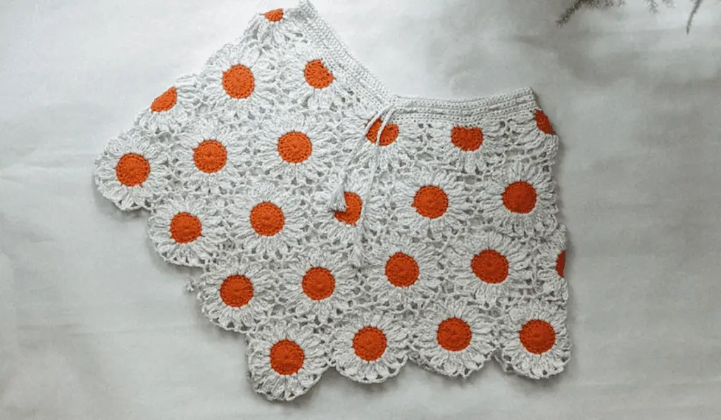 Flower motif crochet shorts with a repeating daisy pattern.