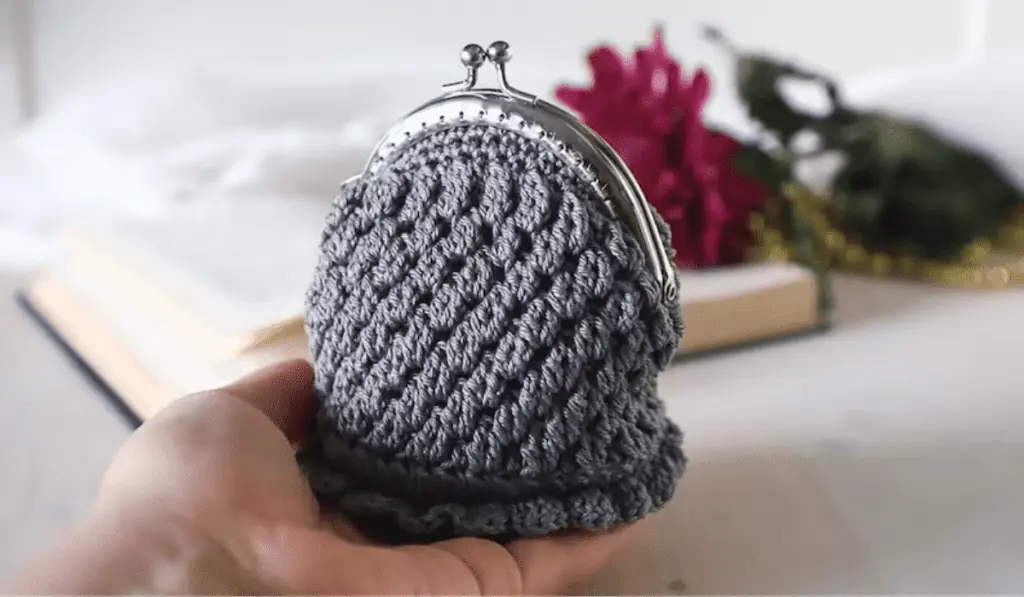 A grey crochet coin purse.