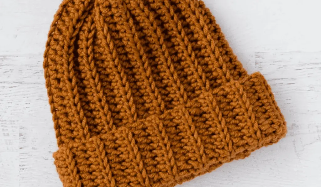 An orange ribbed beanie.