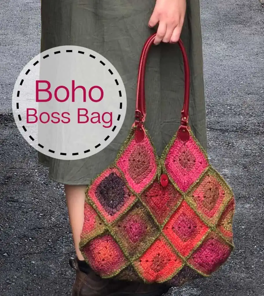 Crochet granny square bag in red, pink and green yarn with red leather straps