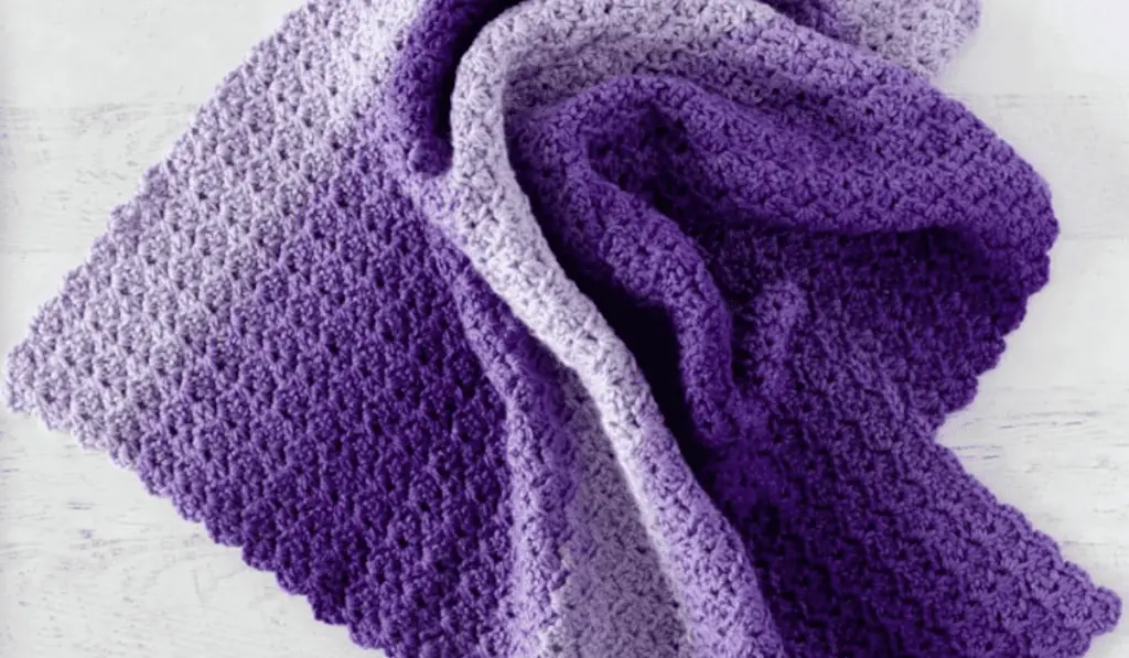 A purple ombre crochet baby blanket pattern.
