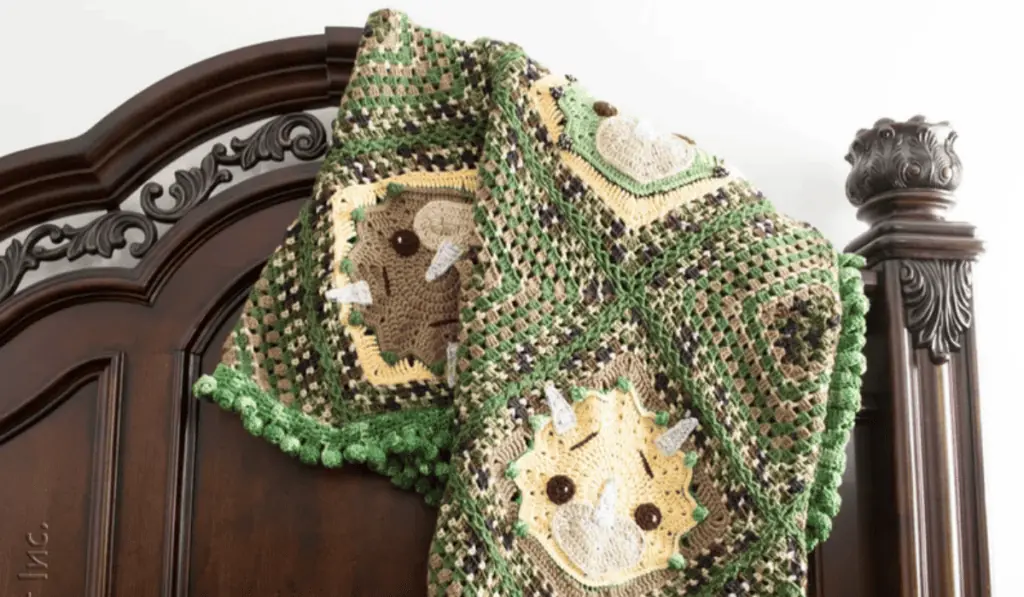 A green and brown dinosaur blanket