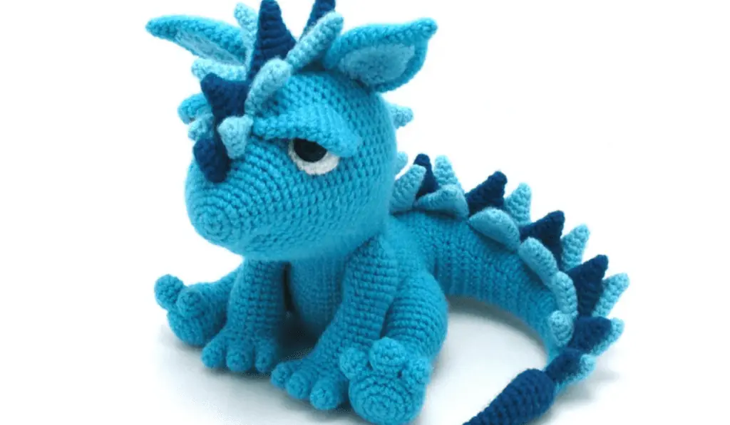 A blue crochet dinosaur