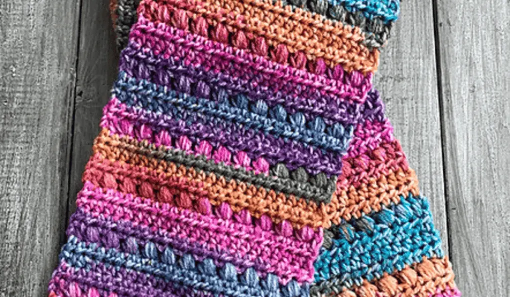 A scarf with a variety of bright colors, including pink, purple, blue, and orange.