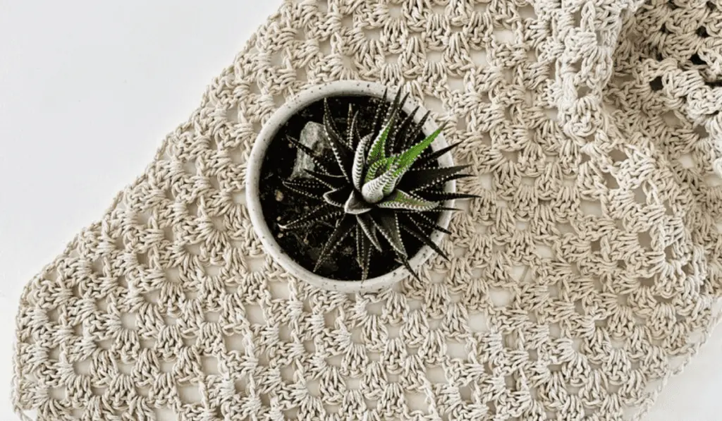 A white crochet table runner