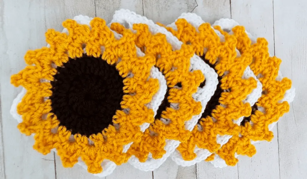 Four granny squares with 3D sunflowers on it.