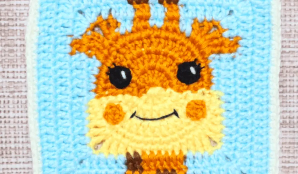 A granny square with a cartoon-looking giraffe on it.