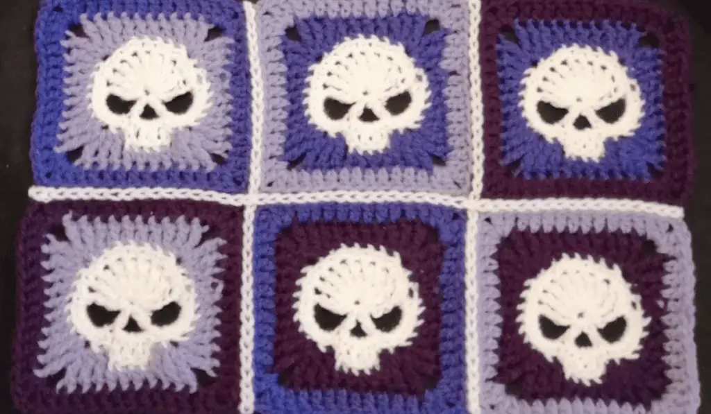 Six skull granny squares stitched together to form a rectangle.