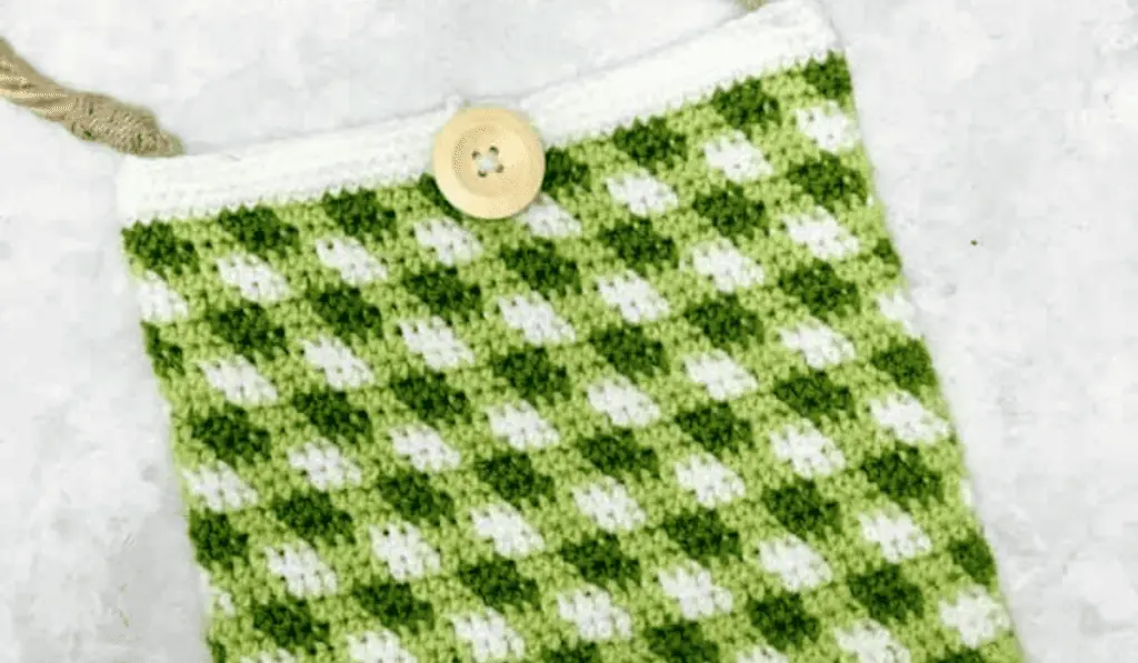A green and white gingham market tote with a button closure.