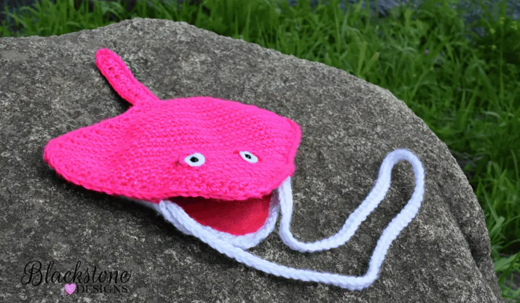 A pink crochet stingray crossbody bag.