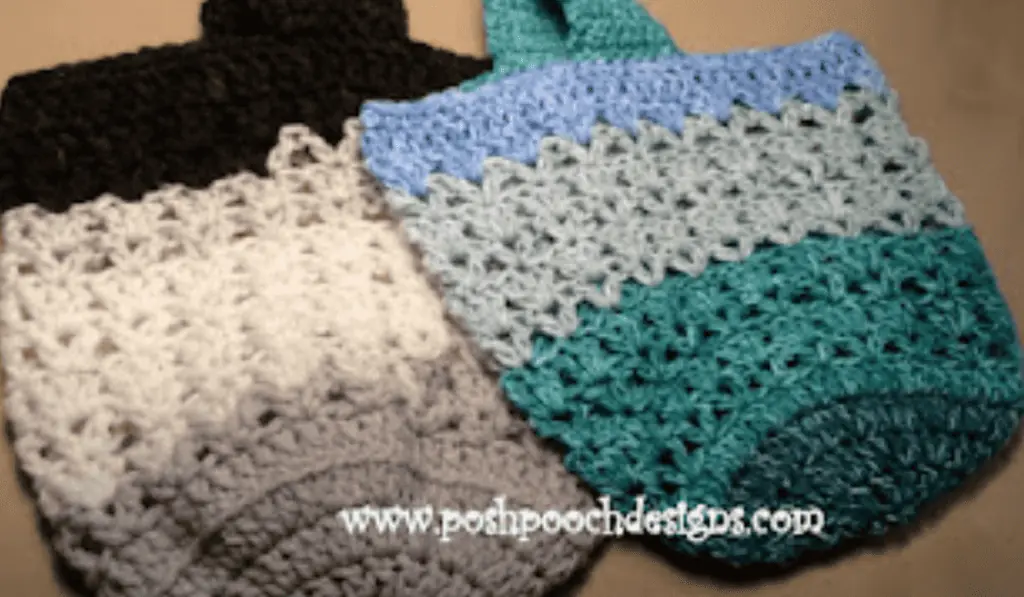 Two crochet market bags, one is color blocked in black, white, and grey. The other is in color blocks of green, seafoam, and blue.