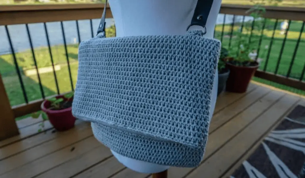 A grey crochet messanger-style bag.