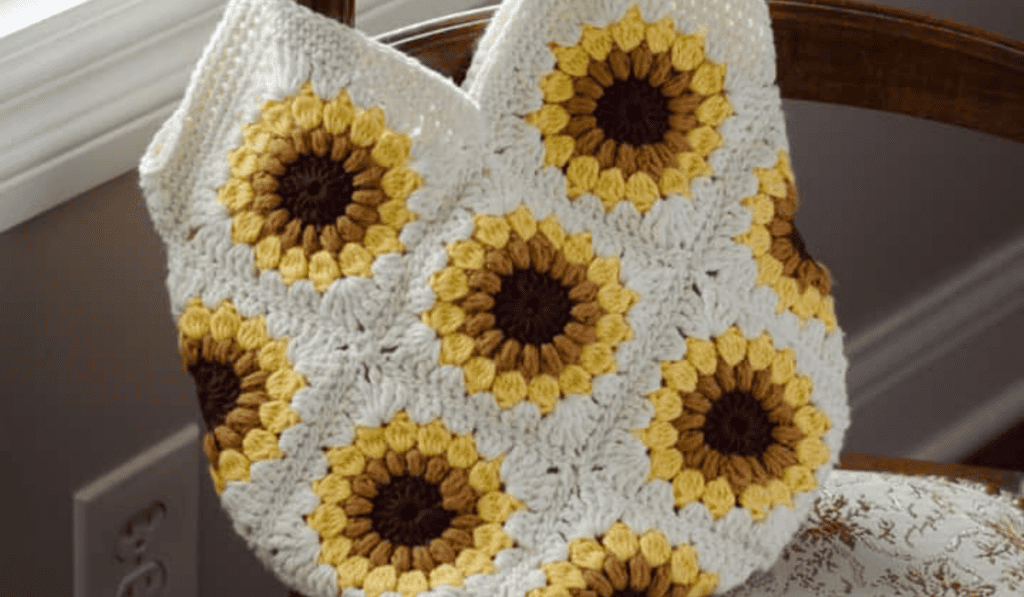 A crochet tote bag with sunflower granny squares