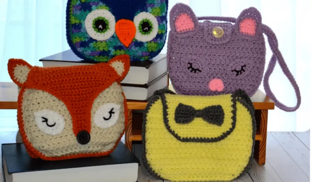 Four crochet bag patterns, including one that looks like an owl, one that looks like a cat, one that looks like a fox, and one that is a a rectangle purse with a bow.