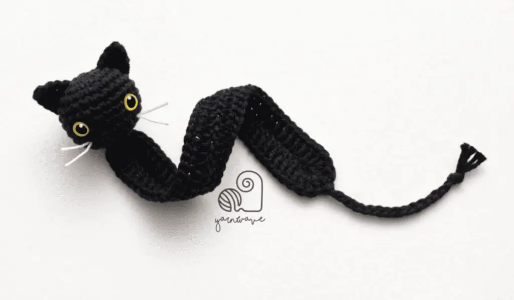 A black crochet cat bookmark.