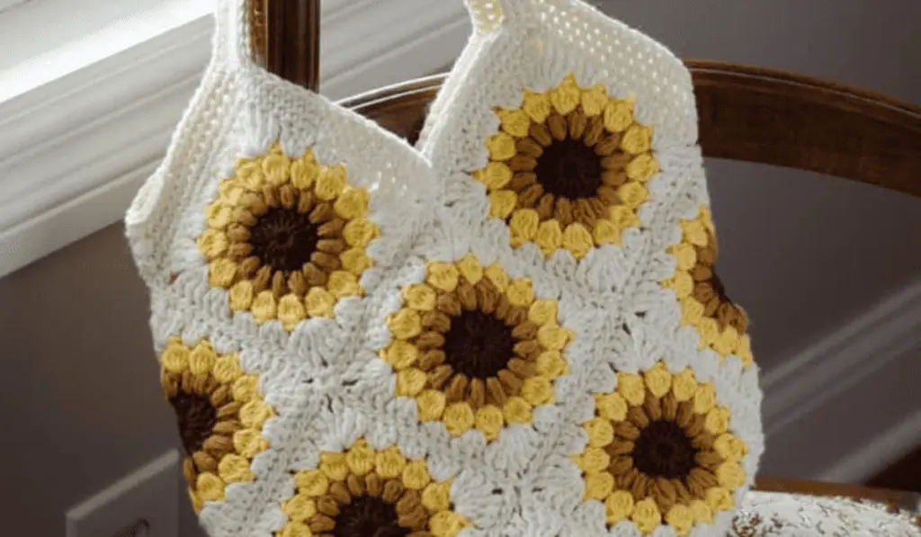 A sunflower crochet tote bag with a white background.
