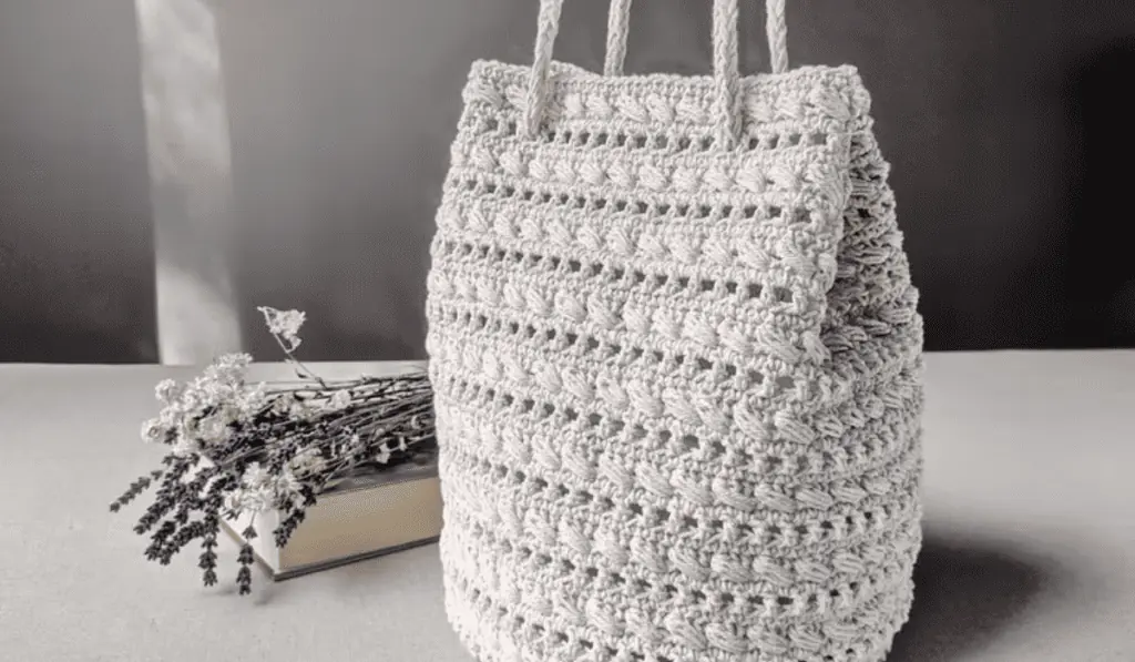 A crochet tote bag with a lot of beautiful teture.