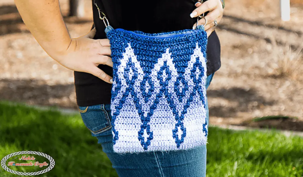 A mosaic crochet crossbody purse.