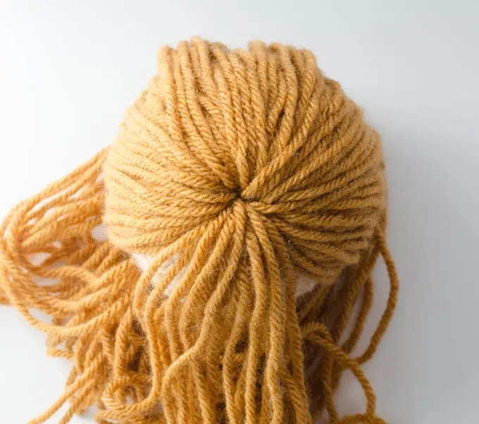 Gold yarn coming out top of head