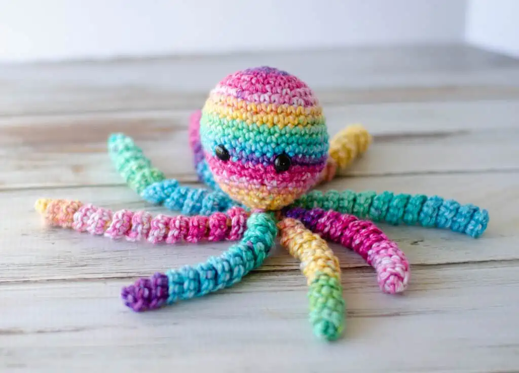 Multi color bright crochet octopus spread out in spiral