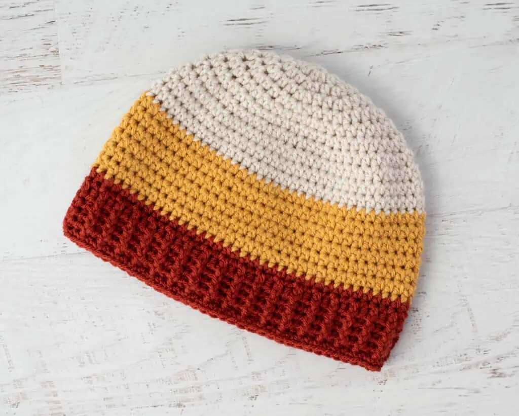 Crochet candy corn hat in cream, rust and yellow yarn