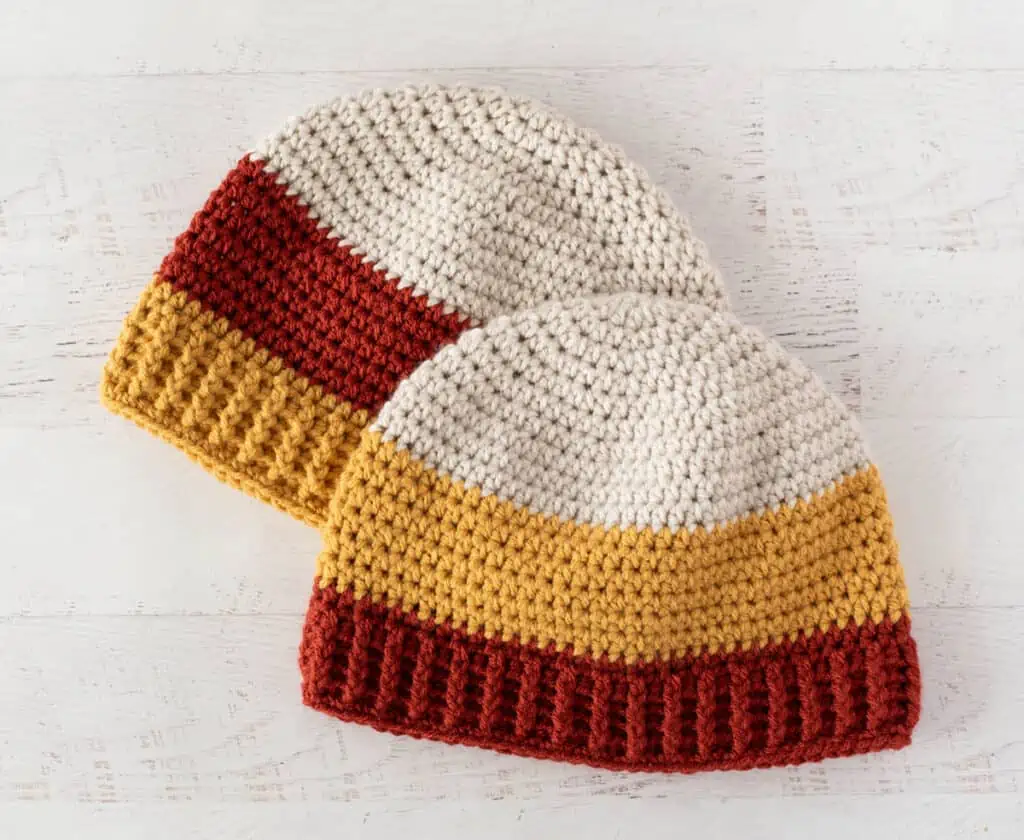 Two crochet candy corn hats in different color ways