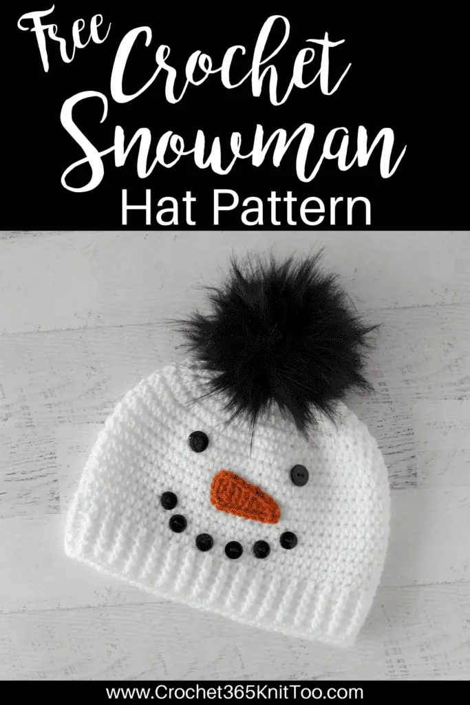 Crochet snowman hat with black buttons, orange carrot nose and black fur pom pom