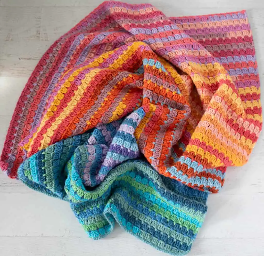 Multicolor yarn crochet afghan in orange, blue, purple assorted shades