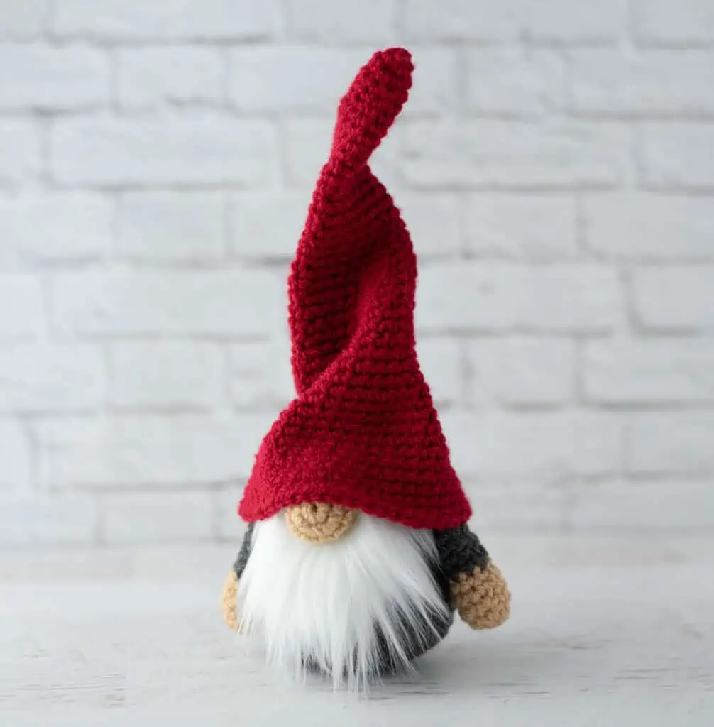 Gray crochet gnome with tall, red hat and furry white beard