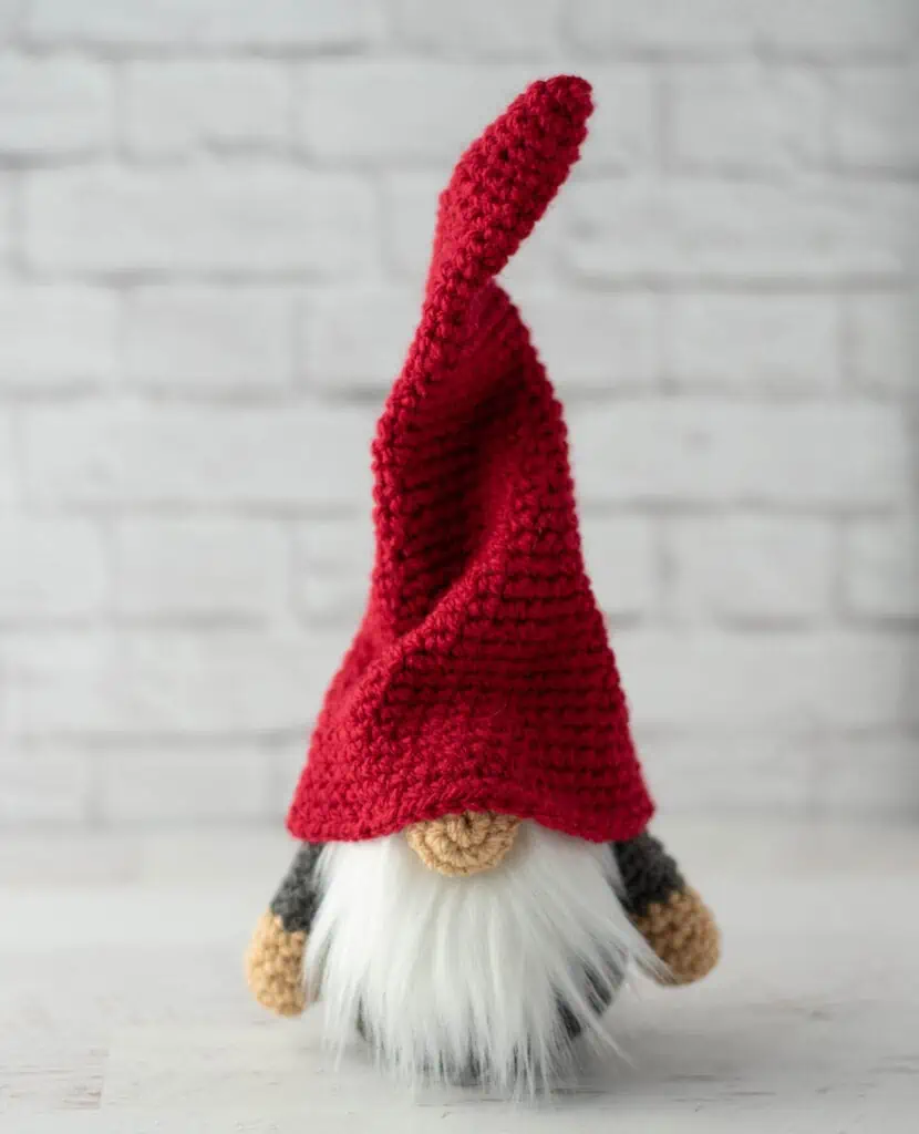 Gray crochet gnome with tall, red hat and furry white beard