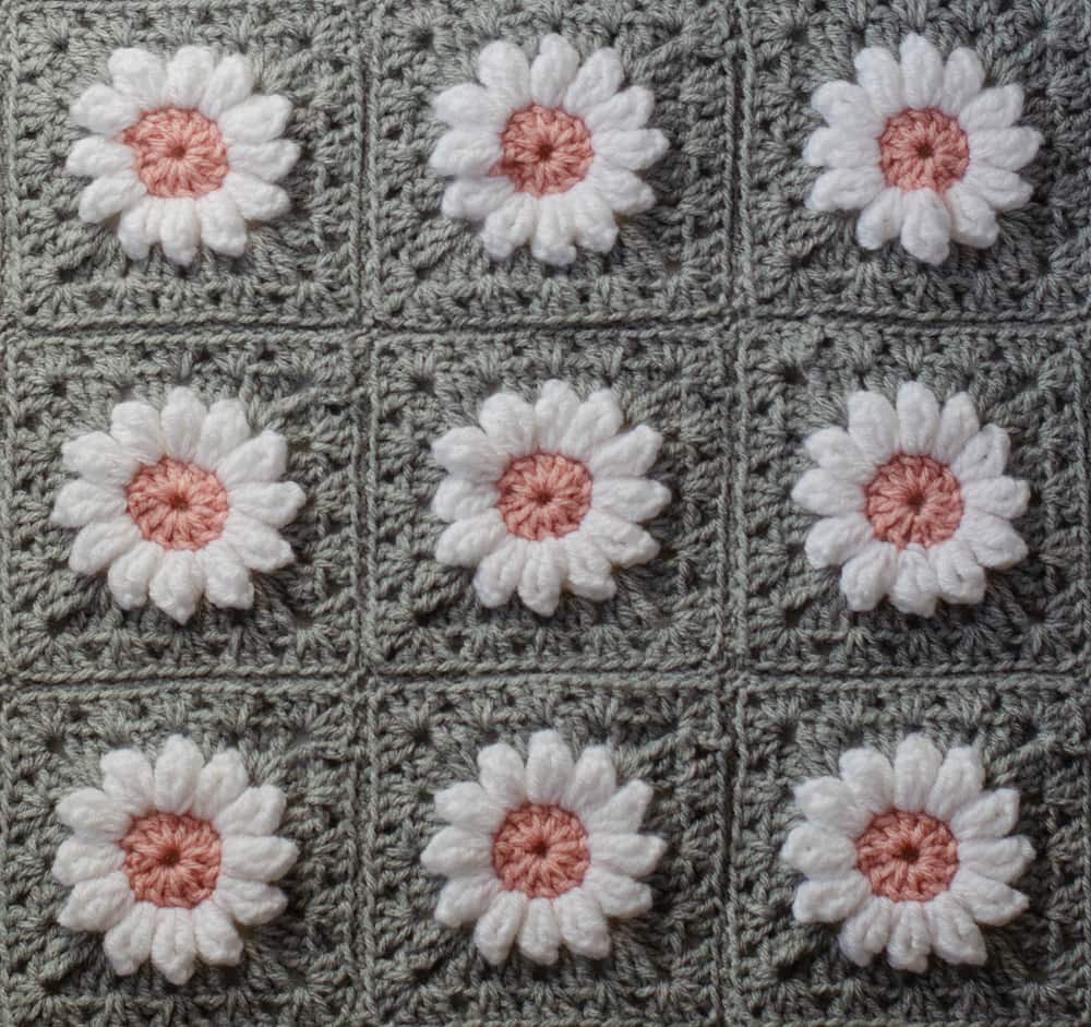 Crochet daisy granny square afghan in gray, pink and white