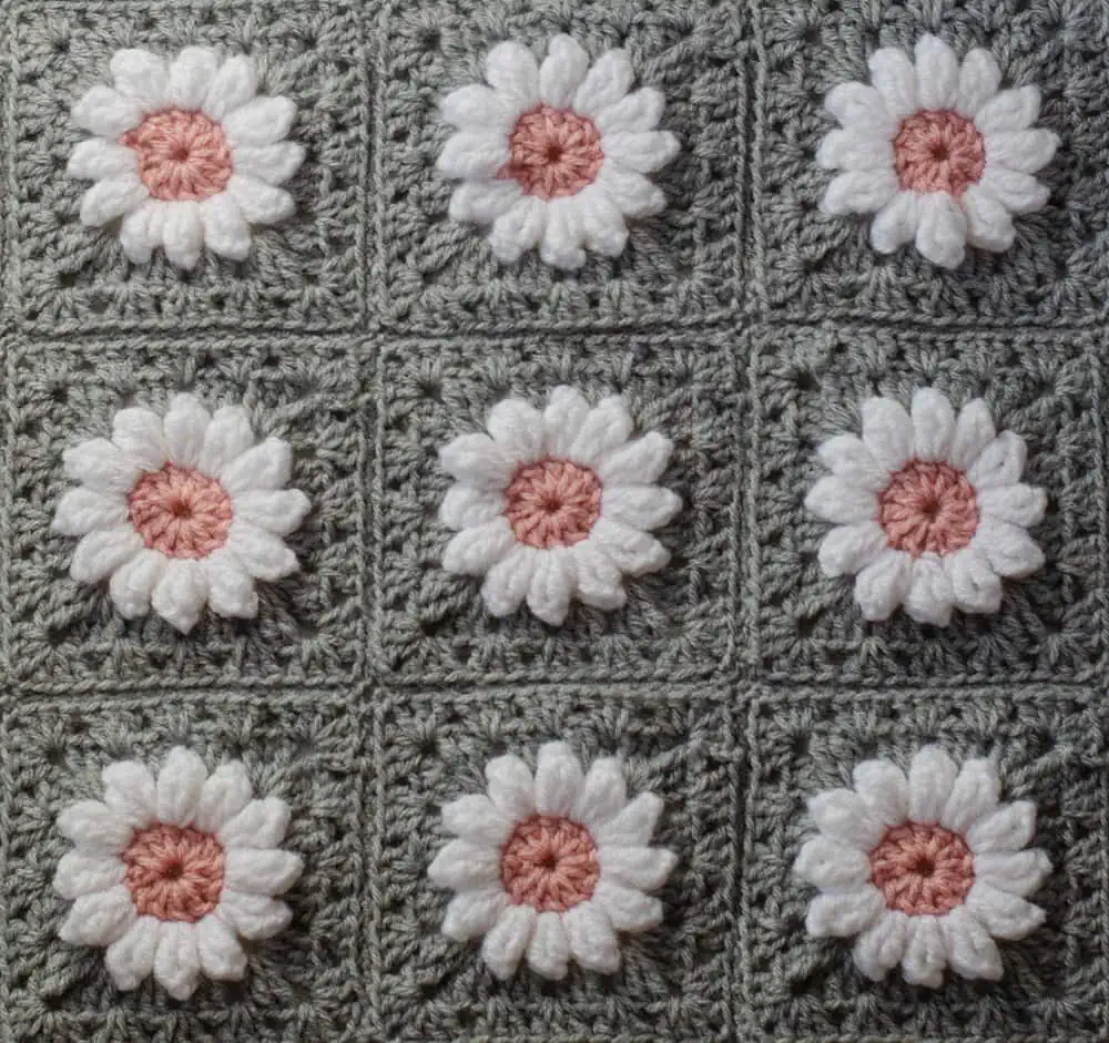 Crochet daisy granny square afghan in gray, pink and white