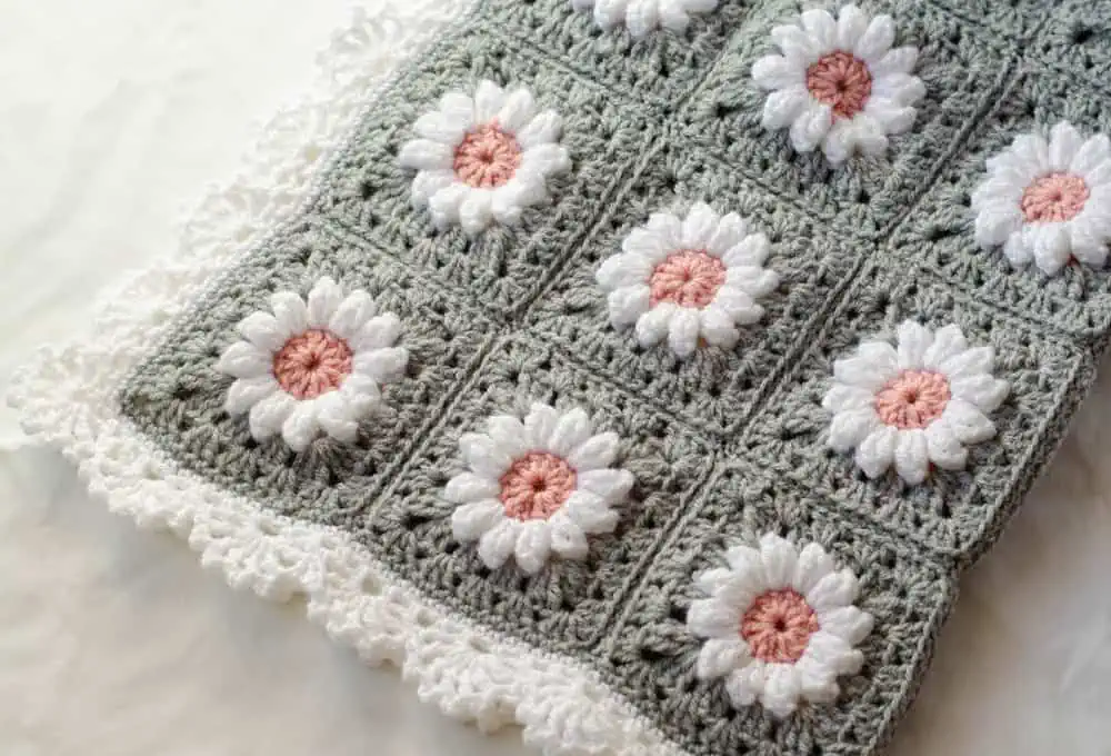 Crochet daisy granny square afghan in gray, pink and white