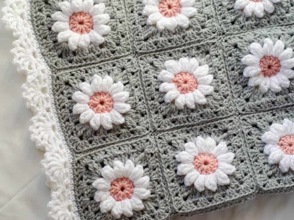 Crochet daisy granny square afghan in gray, pink and white