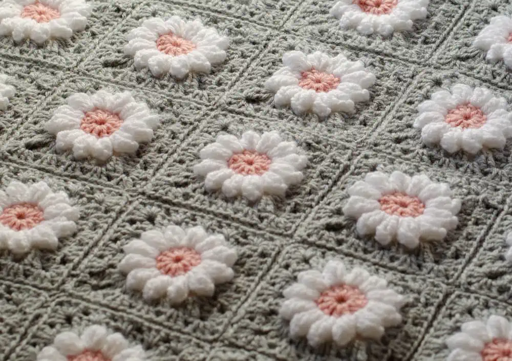 Crochet daisy granny square afghan in gray, pink and white