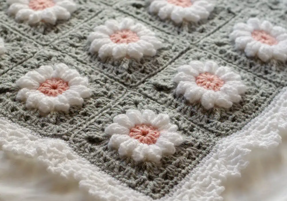 Crochet daisy granny square afghan in gray, pink and white