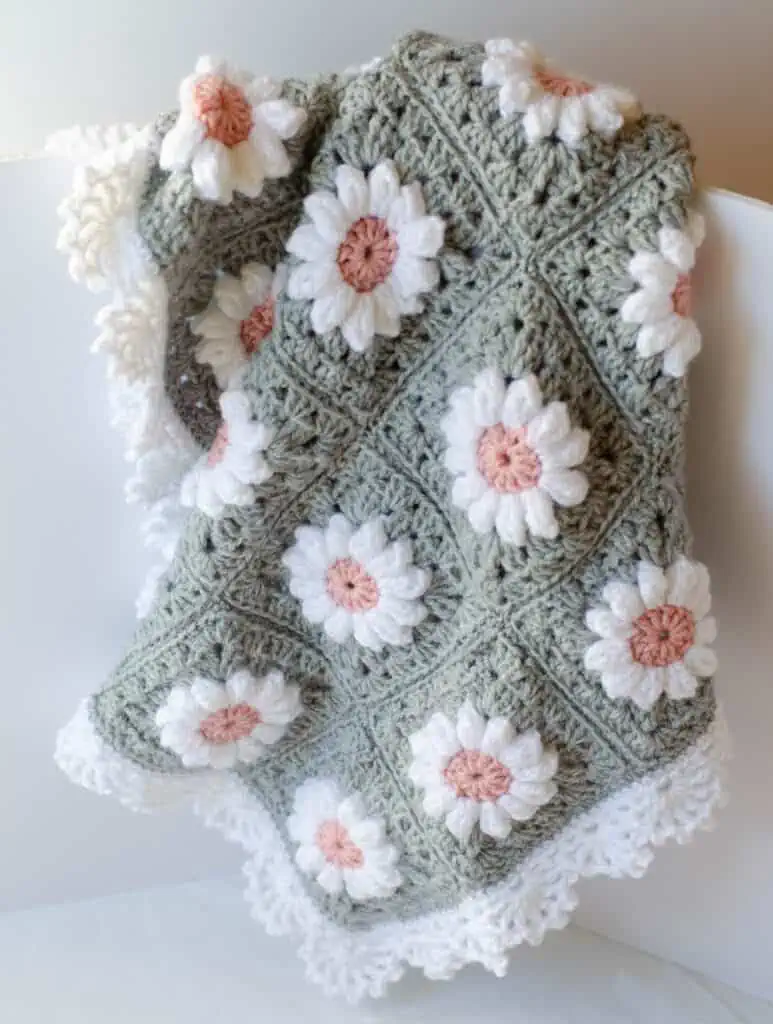 Crochet daisy granny square afghan in gray, pink and white