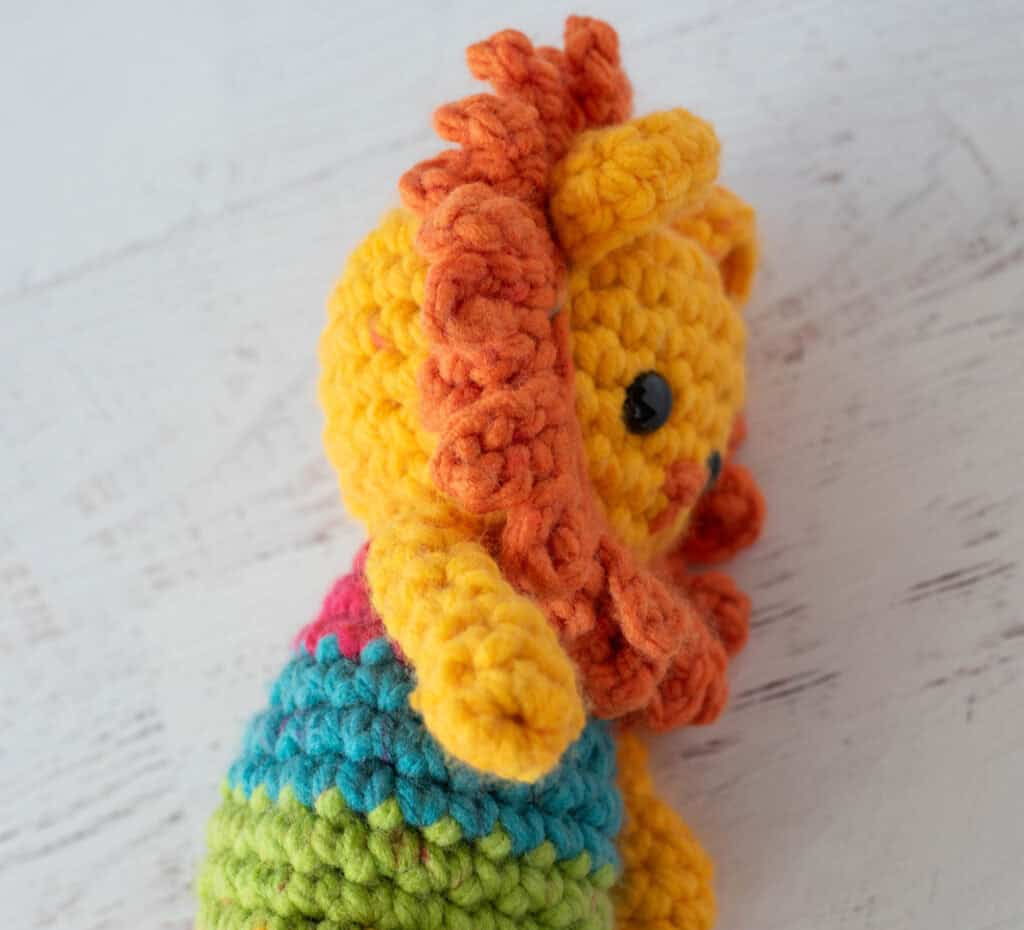 Side view of main on crochet lion.
