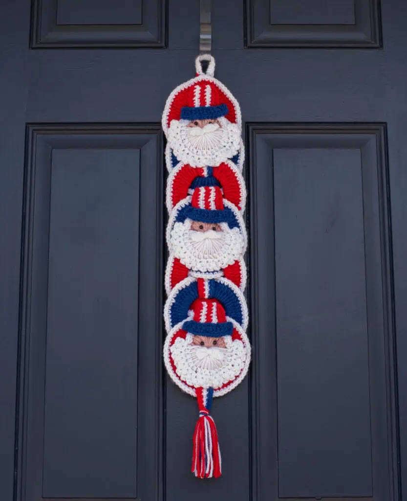 Crochet Uncle Sam Wallhanging in Red, White and Blue Yarn on blue door