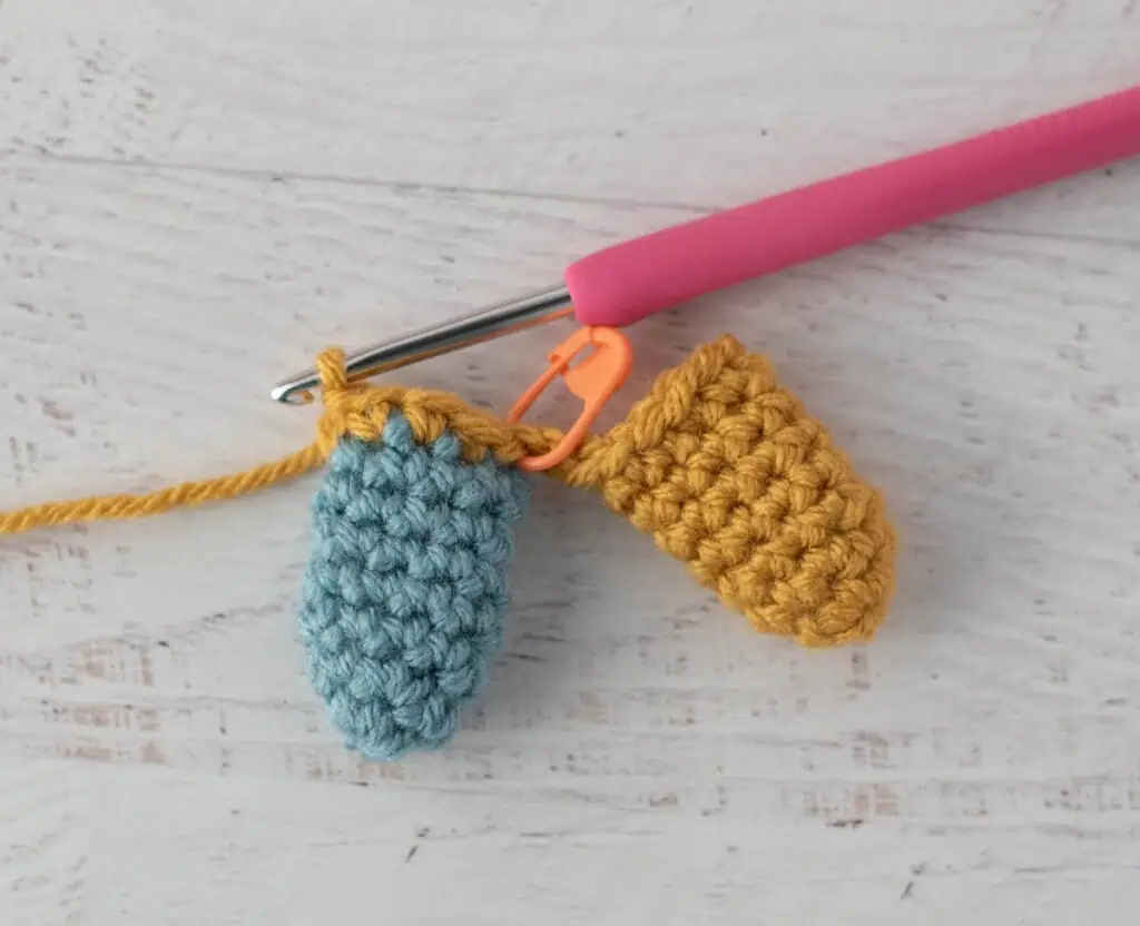 crochet limb connection process with yellow and blue yarn