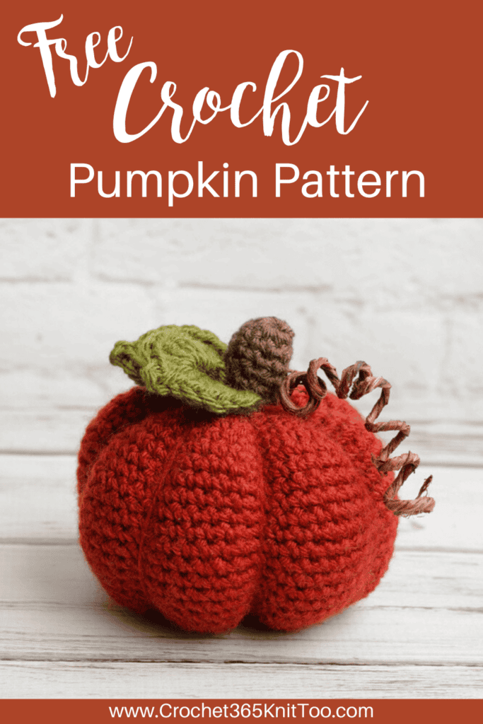 Image of crochet pumpkin in orange with brown stem and green leaves