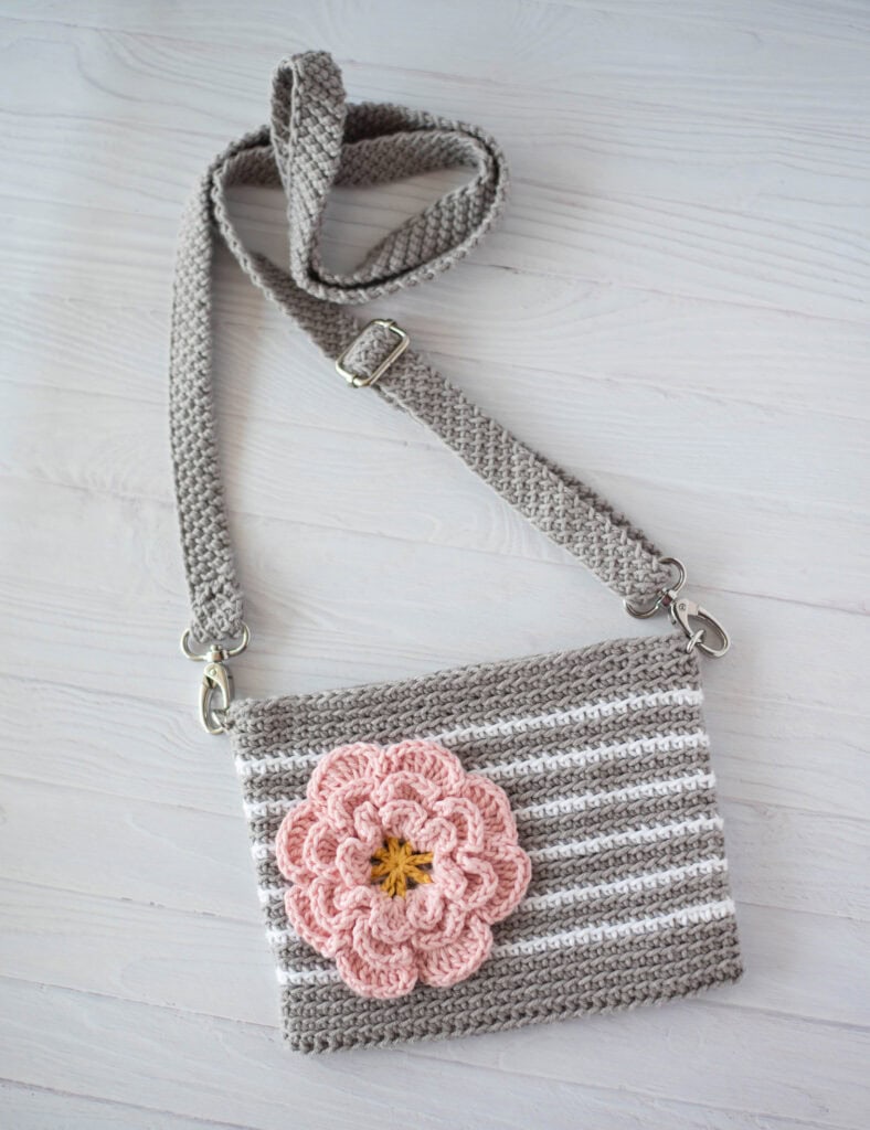 Gray crochet bag with white stripes and pink flower