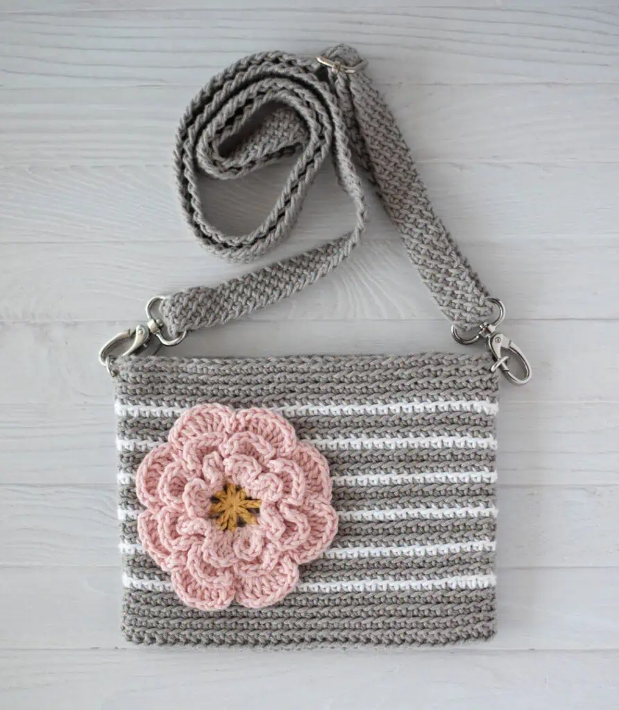 Gray crochet bag with white stripes and pink flower