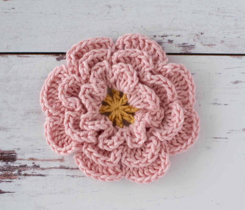 Pink crochet flower with yellow center