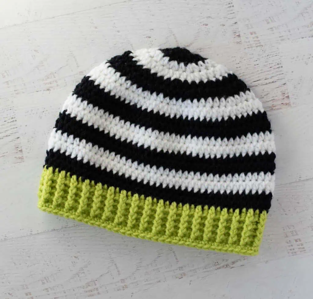 Black and white crocheted beanie with bright green